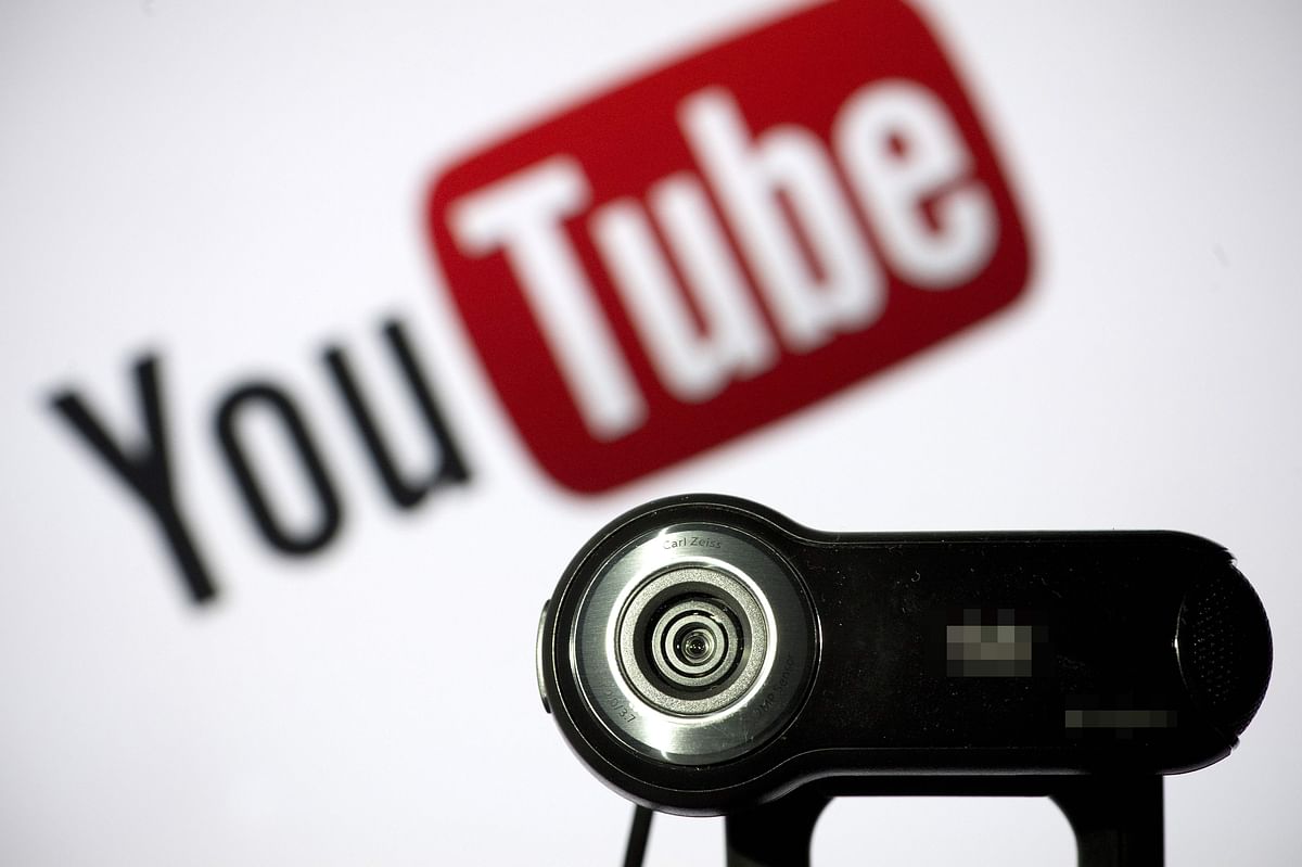 In this file photo taken on 28 June 2013 a webcam is positioned in front of YouTube`s logo in Paris. Google agreed to pay a $170 million fine to settle charges that it illegally collected and shared data from children on its YouTube video service without consent of parents, US officials announced on 4 September 2019. Photo: AFP