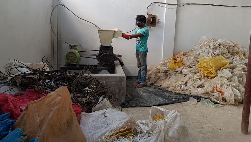 A worker recycles polythene bags in the recycling plant. Photo: UNB