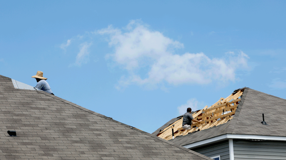 Construction workers on the roofs of adjacent houses labour under blue skies after a tornado spawned by Hurricane Dorian damaged homes in Carolina Shores, North Carolina, US, 6 September 2019. Photo: Reuters