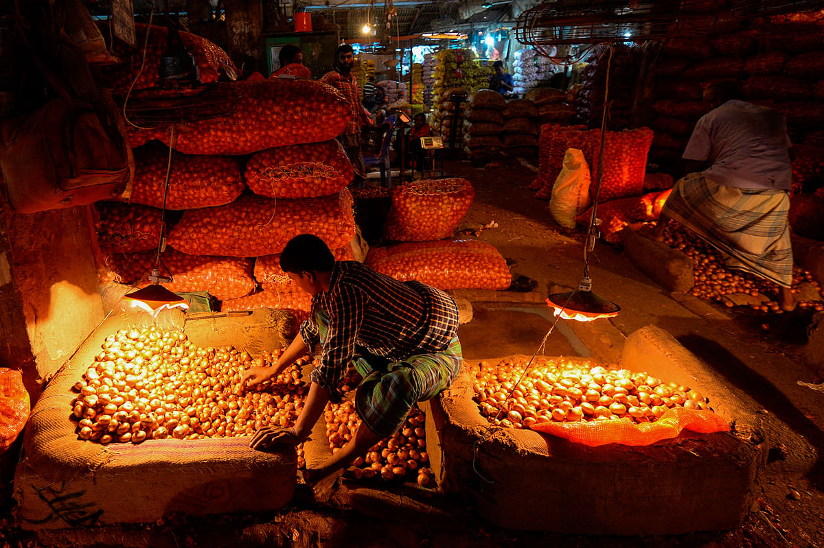 A vendor arranges onions at Karwan Bazar wholesale market in Dhaka on 8 September, 2019. Photo: AFP