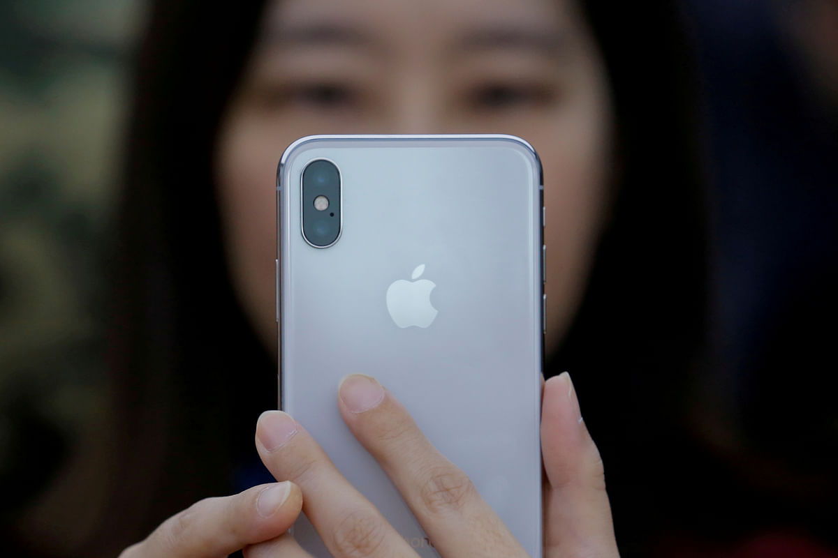An attendee uses a new iPhone X during a presentation for the media in Beijing. Reuters file photo