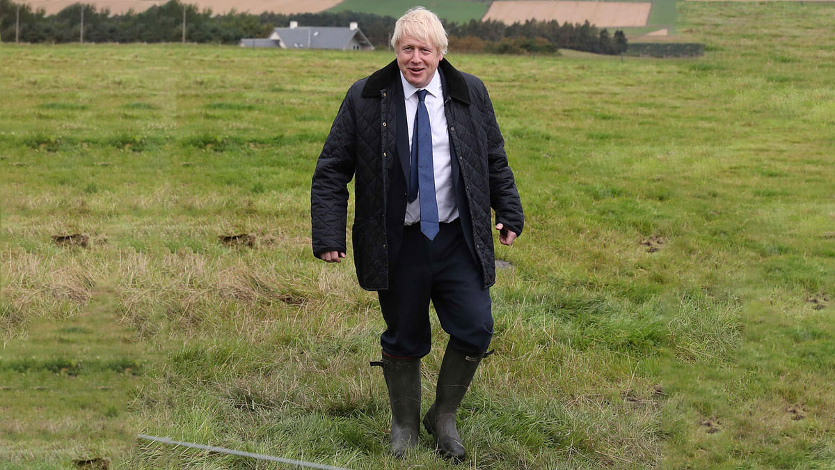 Britain`s prime minister Boris Johnson smiles as he is shown around Darnford Farm in Banchory near Aberdeen in Scotland on 6 September 2019. Prime minister Boris Johnson heads to Scotland on Friday in campaign mode despite failing to call an early election after MPs this week thwarted his hardline Brexit strategy. Photo: AFP