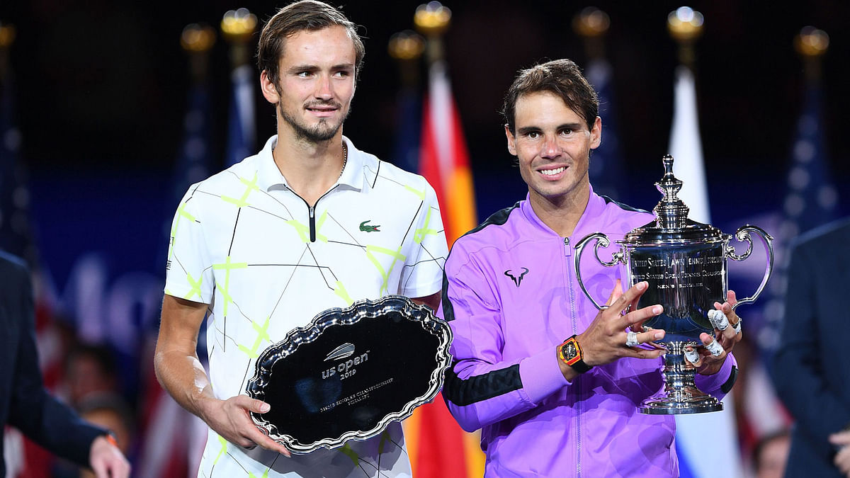 Rafael Nadal of Spain (R) holds the trophy after his win over Daniil Medvedev of Russia (L) during the men`s Singles Finals match at the 2019 US Open at the USTA Billie Jean King National Tennis Center in New York on Sunday. Photo: AFP