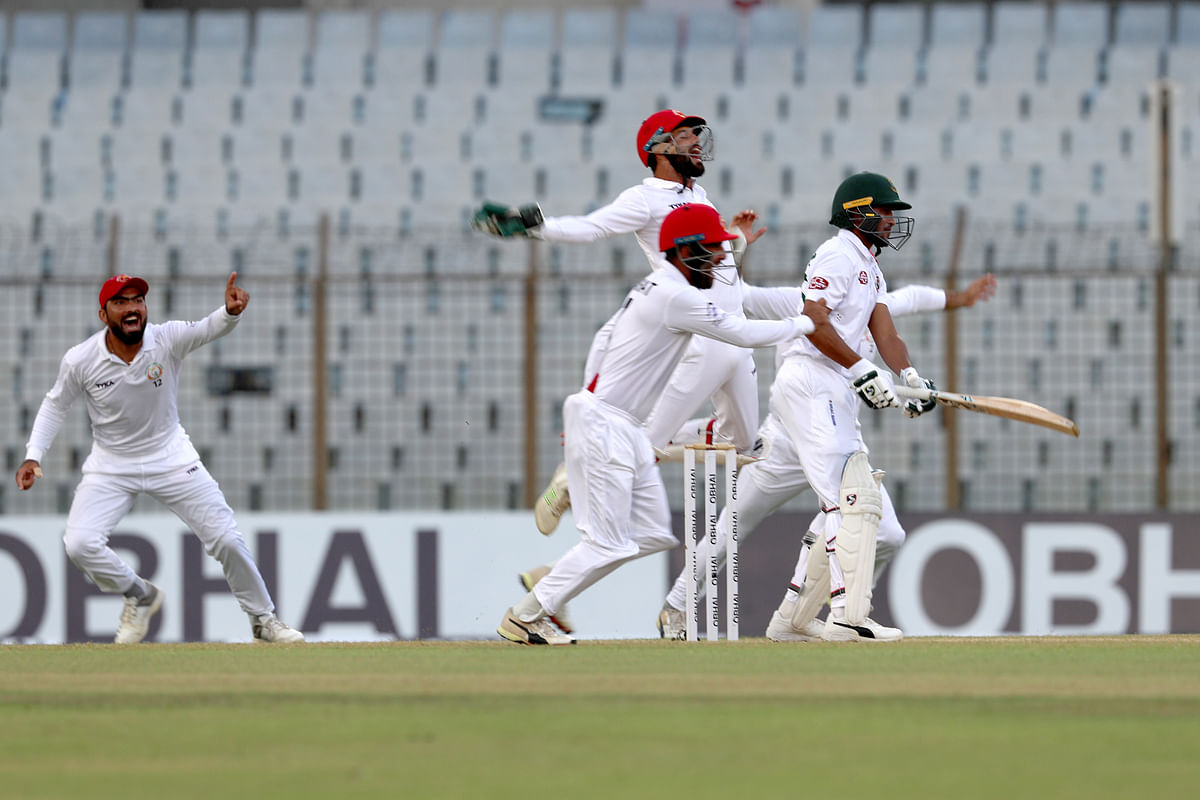 Afghanistan players celebrate their 224-run victory against Bangladesh in the one-off Test in Chattogram on Monday. AFP