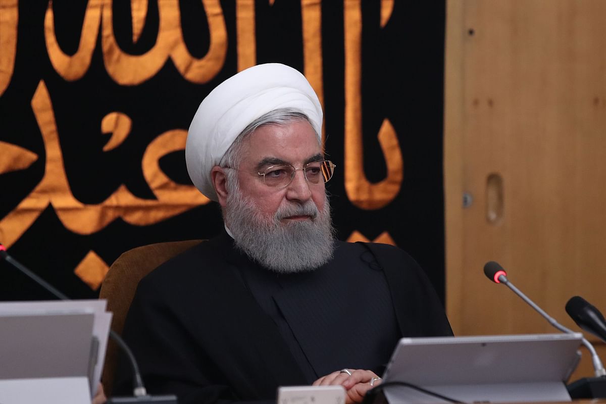 A handout picture provided by the Iranian presidency on 11 September shows president Hassan Rouhani chairing a cabinet meeting in the capital Tehran, with a banner behind him reading in Arabic `O martyr Abu al-Abbas al-Hussein`, hung up during the Ashura mourning period and referring to the prophet Mohamed`s grandson Imam Hussein ibn Ali. Photo: AFP