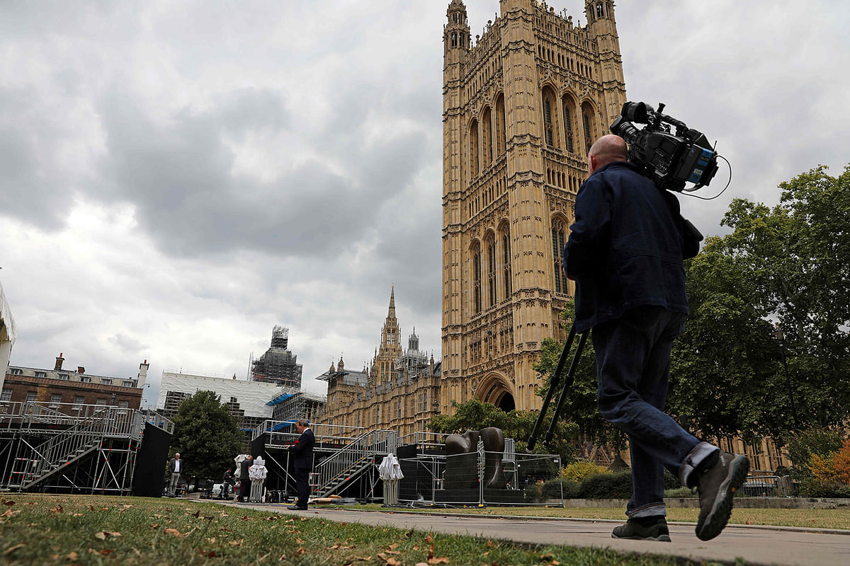 Members of the media work on College Green, where broadcaster`s had set up a temporary studios, opposite the Houses of Parliament in central London on Tuesday. Photo: AFP