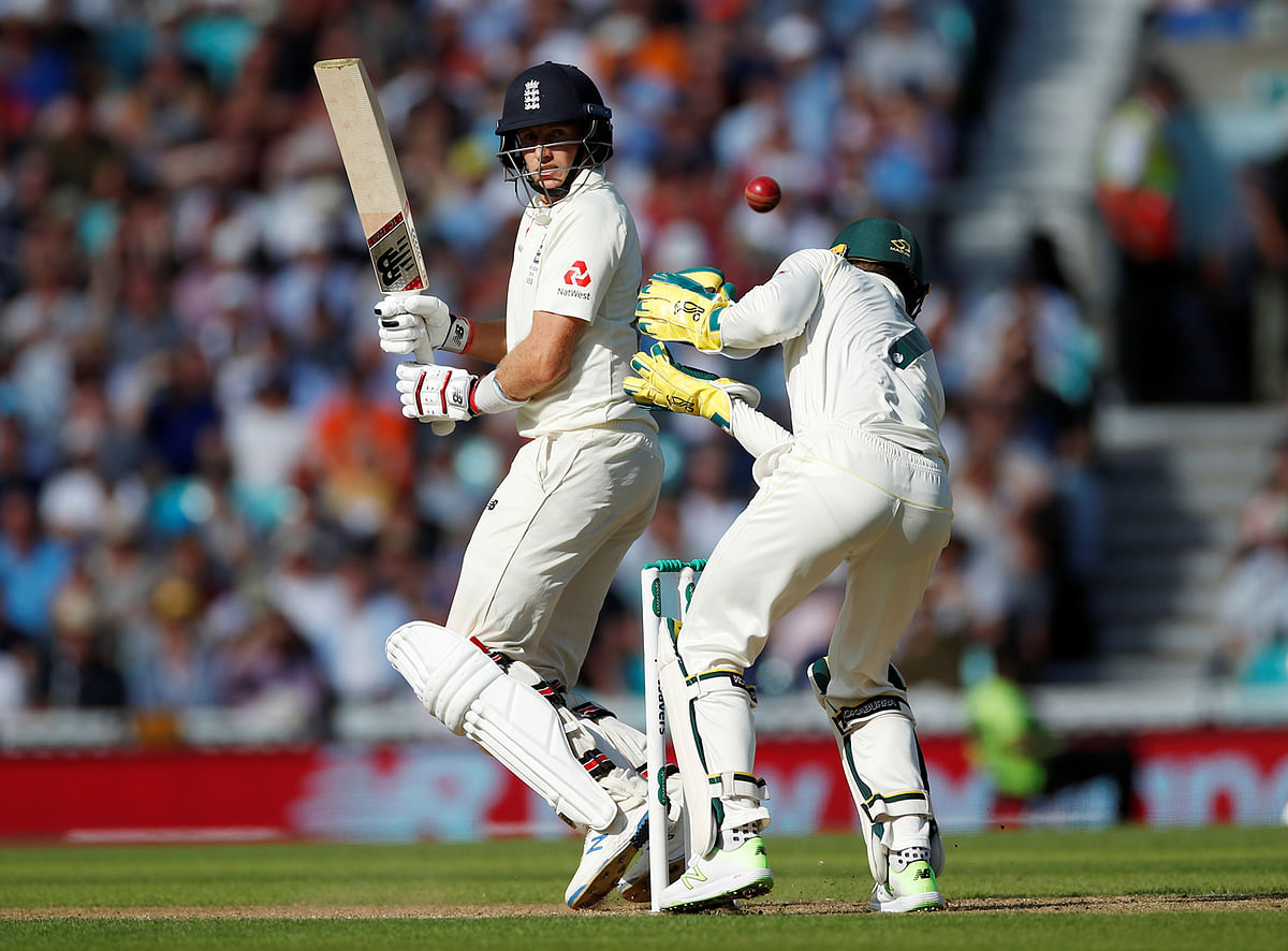 England`s Joe Root and Australia`s Tim Paine in action. Photo: Reuters