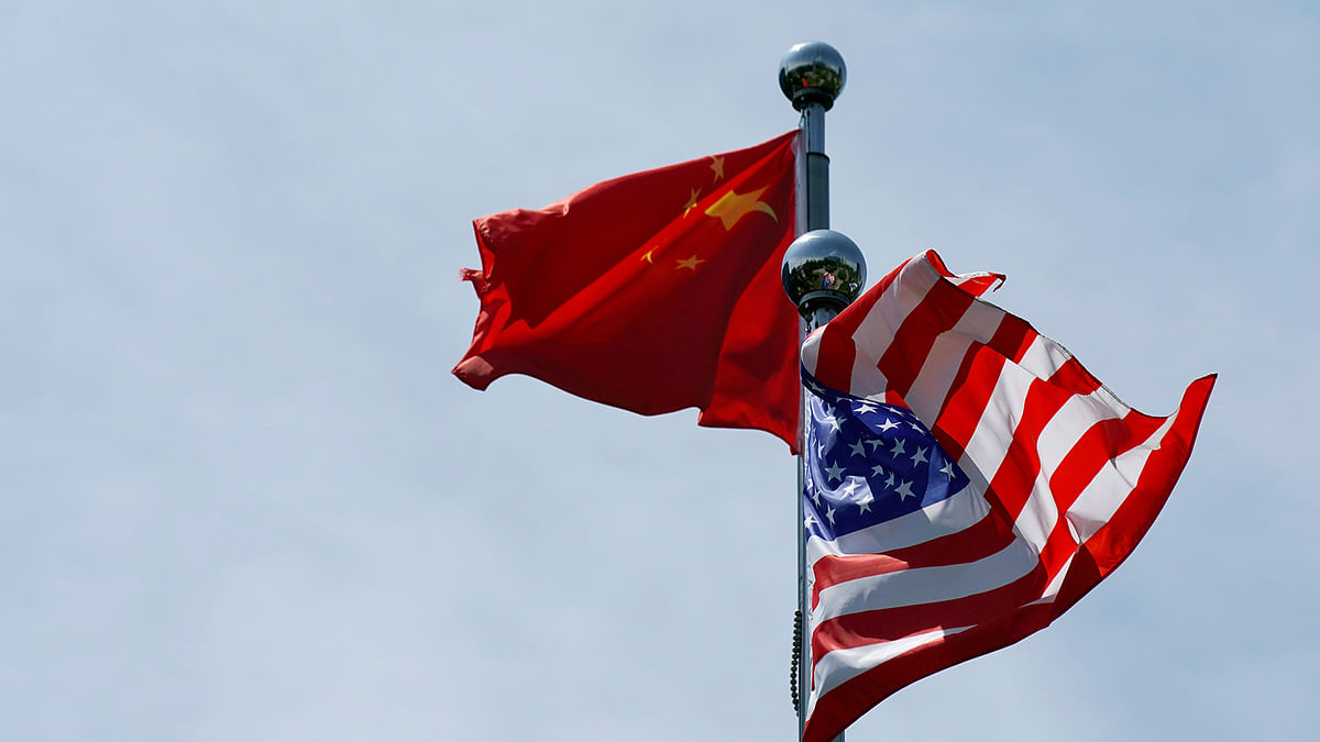 Chinese and US flags flutter near The Bund, before US trade delegation meet their Chinese counterparts for talks in Shanghai, China on 30 July 30. Photo: Reuters