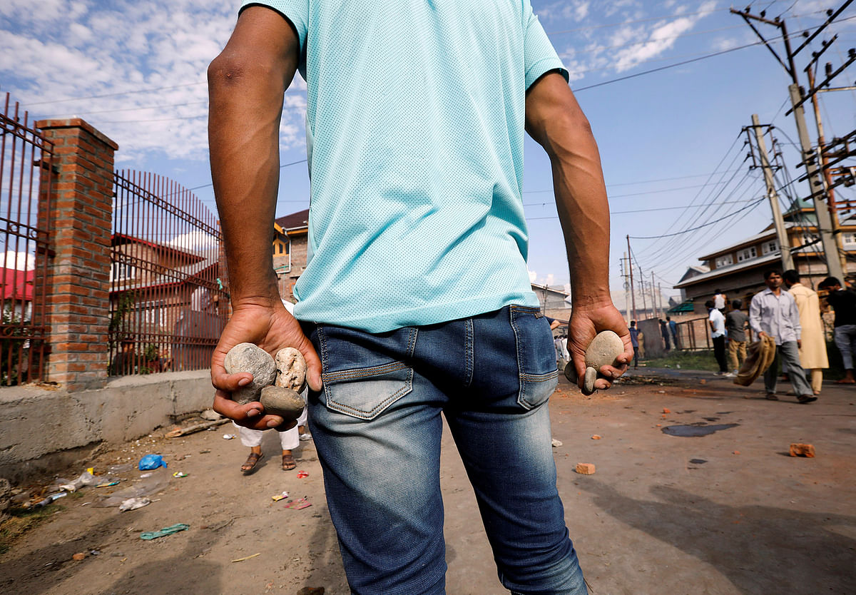 A Kashmiri man holds stones during clashes with Indian security forces, after scrapping of the special constitutional status for Kashmir by the Indian government, in Srinagar, 23 August, 2019. Photo: Reuters
