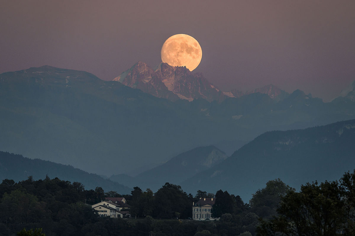 A near full moon rises behind The French Alps as seen from Geneva on 12 September, 2019. Photo:AFP