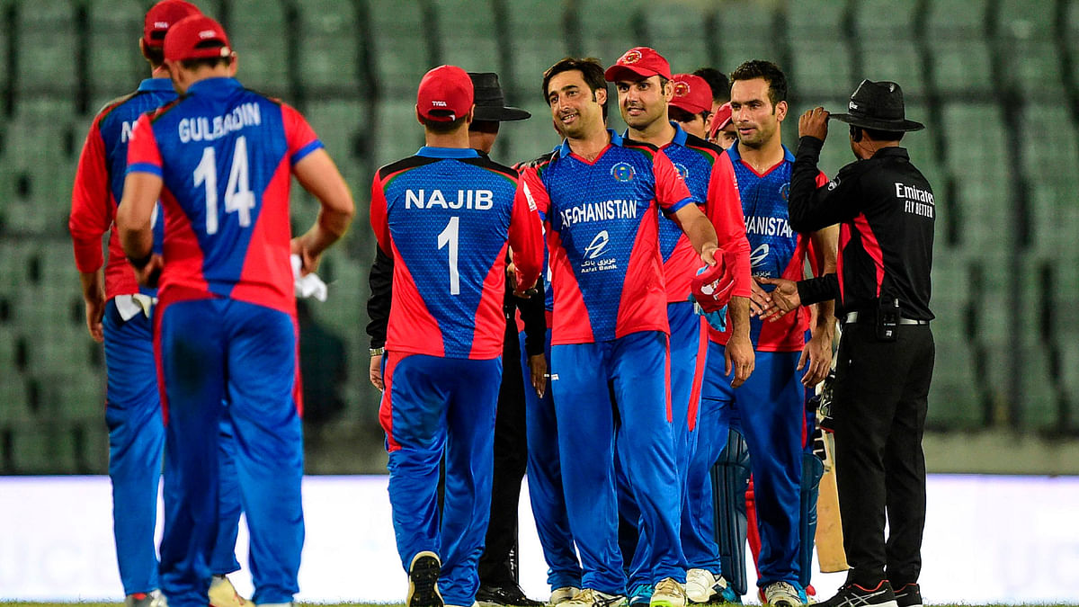Afghanistan cricketers congratulate each other after winning the second match between Afghanistan and Zimbabwe in the T20 Tri-nations cricket series at the Sher-e-Bangla National Stadium in Dhaka on 14 September, 2019. Photo: AFP