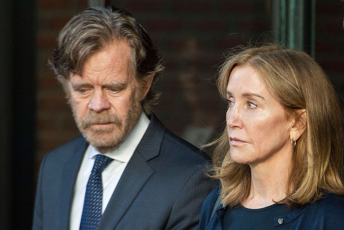 Actress Felicity Huffman, escorted by her husband William H. Macy, exits the John Joseph Moakley United States Courthouse in Boston, where she was sentenced by Judge Talwani for her role in the College Admissions scandal on Friday. Photo: AFP