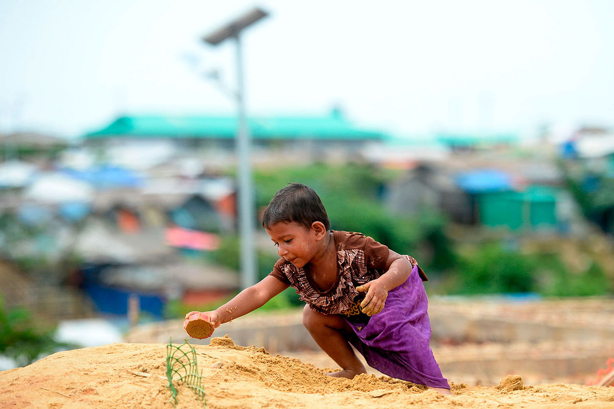 A Rohingya refugee girl plays with sand at the Kutupalong refugee camp in Ukhia on 13 Setember 2019. Photo: AFP