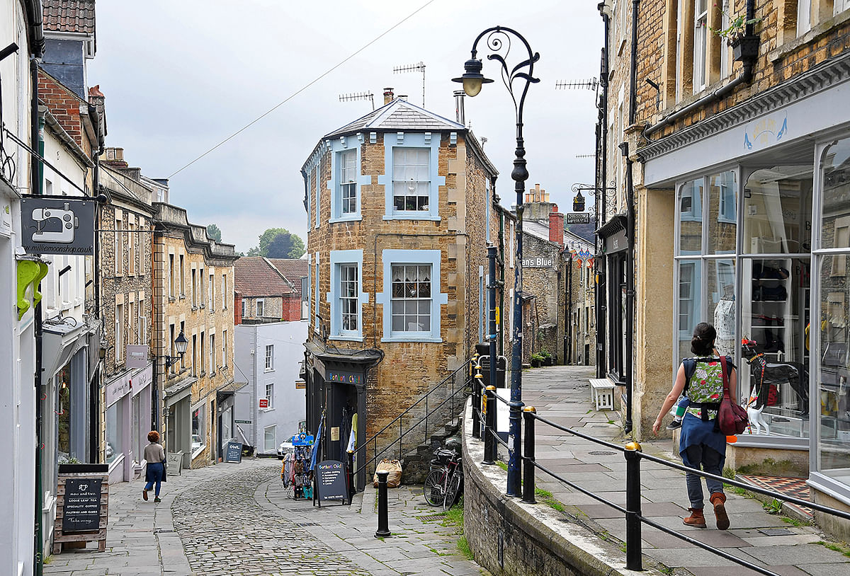 Shoppers are seen walking in one of the older commercial streets in Frome. Picture taken 25 June 2019. Photo: Reuters