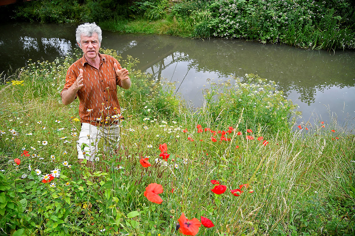Activist, environmentalist, community leader and undertaker Peter Macfadyen stands on the banks of the River Frome, in Frome. Picture taken 25 June 2019. Photo: Reuters