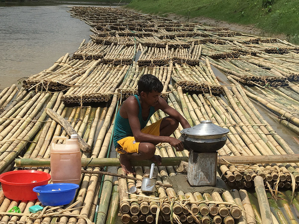 A worker busy cooking bamboos to be taken to Karnafuli paper mill floating on the river at Babupara, Dighinala, Khagrachhari on 15 September. Photo: Palash Barua