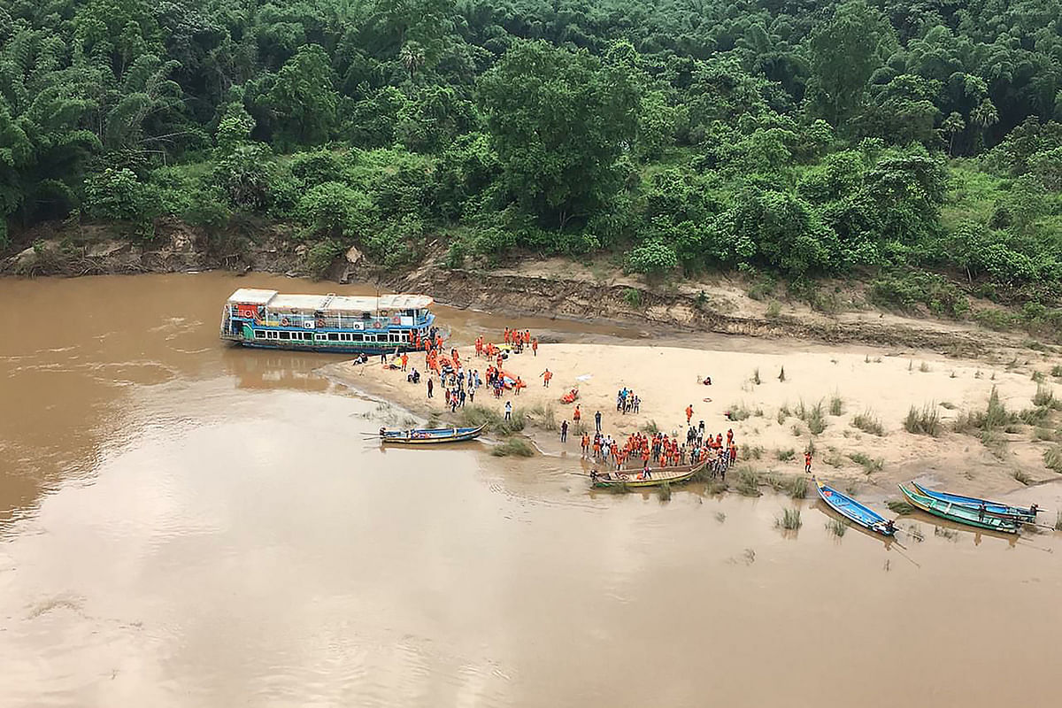 Members of National Disaster Response Force (NDRF) along with other government officials search for missing people, after a tour boat capsized in Godavari river, near Rajahmundry in Andhra Pradesh state. Indian authorities were engaged in a major search and rescue operation on Monday to find 39 people missing after their tour boat capsized in a fast-flowing swollen river. Photo: AFP