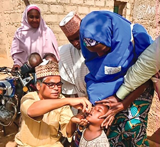 A child being orally vaccinated by Anisur Rahman at Nigeria.