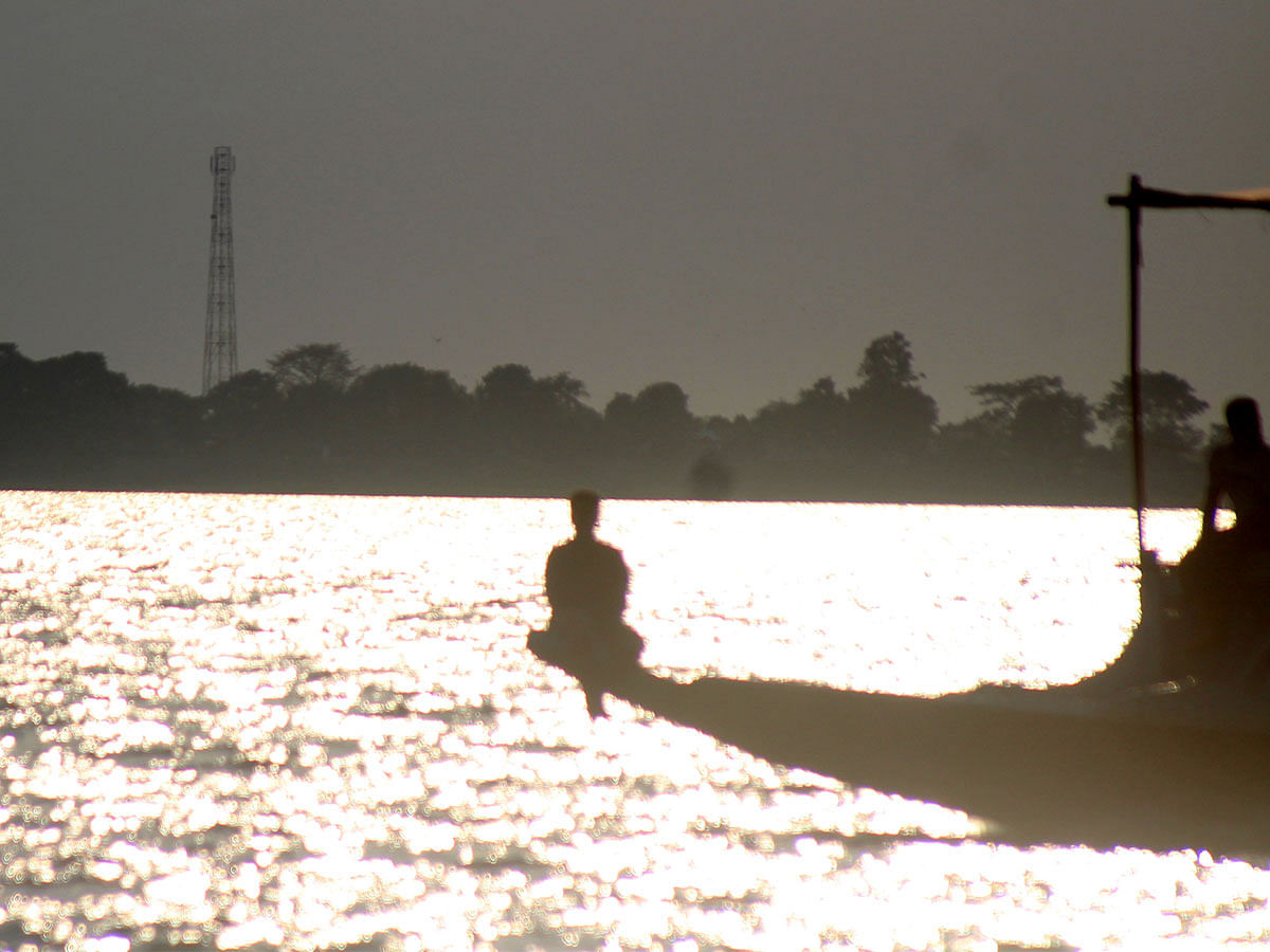 A man sitting on a boat during sunset at Nikli Haor of Kishoreganj. The picture was taken on 17 September 2019. Photo: Tafsilul Aziz