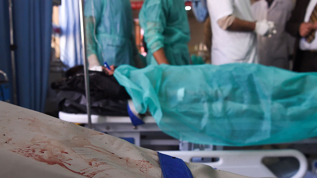 Blood stains are pictured on a hospital bed next to a wounded Afghan man receiving treatment at the Wazir Akbar Khan hospital following a blast in Kabul on Tuesday. Photo: AFP