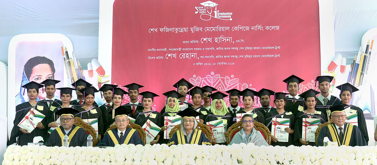 Prime minister Sheikh Hasina and her younger sister Sheikh Rehana take part in a photo session with the pioneering graduates of the Sheikh Fazilatunnesa Mujib Memorial KPJ Specialised Hospital in Kashimpur of Gazipur on Wednesday. Photo: PID