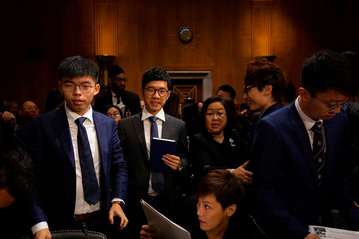 Hong Kong pro-democracy activists Joshua Wong (L), Nathan Law (2nd L) and Hong Kong Cantopop singer, actress and LGBT activist Denise Ho (C, bottom) leave after a hearing before the Congressional-Executive Commission on China at the Dirksen Senate Office Building on Capitol Hill in Washington, DC, on 17 September. Photo: AFP