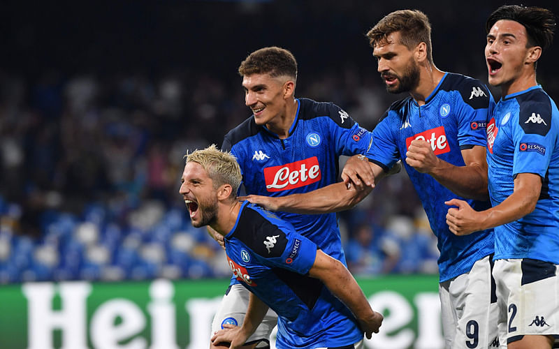 Napoli’s Belgian forward Dries Mertens (Front) celebrates with (FromL) Napoli’s Italian defender Giovanni Di Lorenzo, Napoli’s Spanish forward Fernando Llorente and Napoli’s Macedonian defender Eljif Elmas after scoring a penalty during the UEFA Champions League Group E football match Napoli vs Liverpool on Tuesday. Photo: AFP