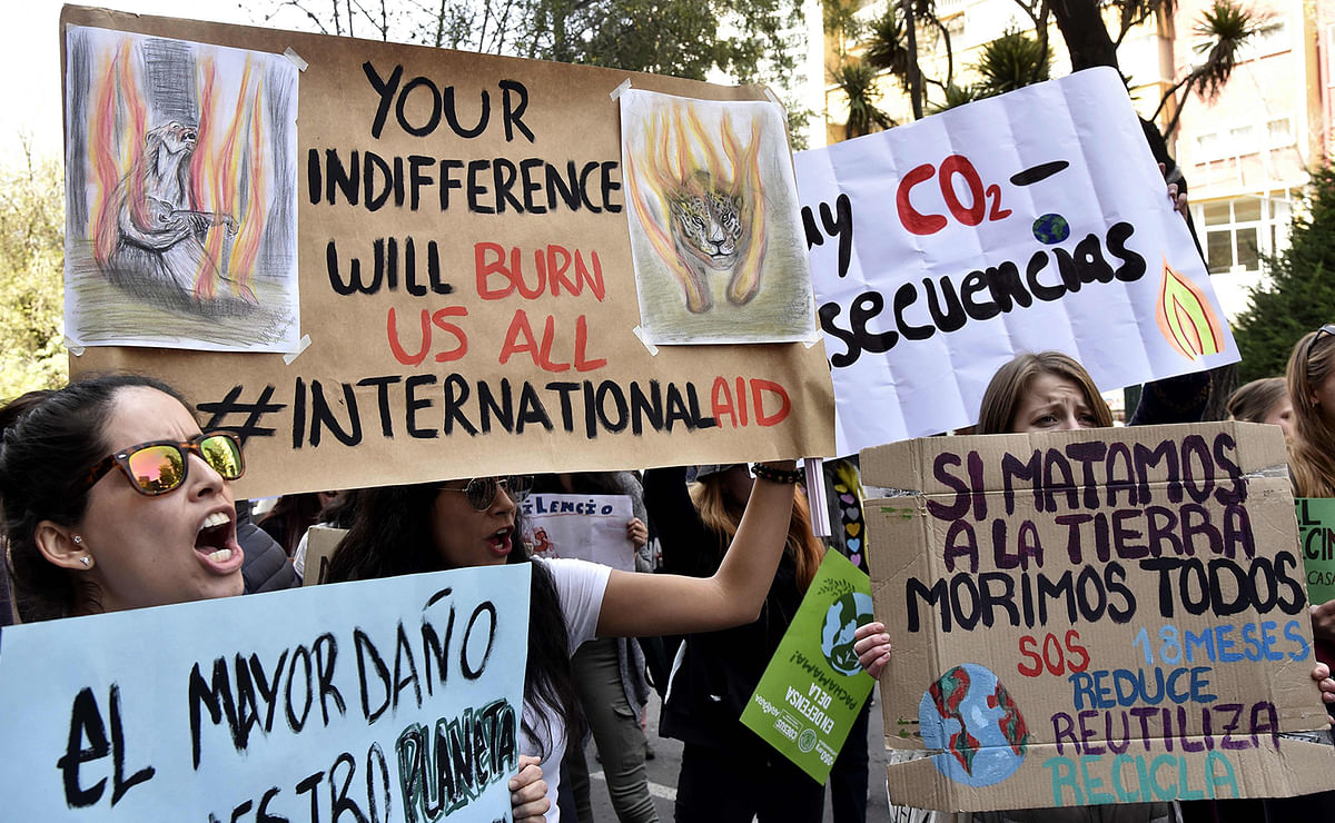 Environmental activists hold signs during a protest against forest fires, in La Paz, on 20 September, 2019, in the framework of the `Friday for the planet` global demo against climate change. Photo: AFP