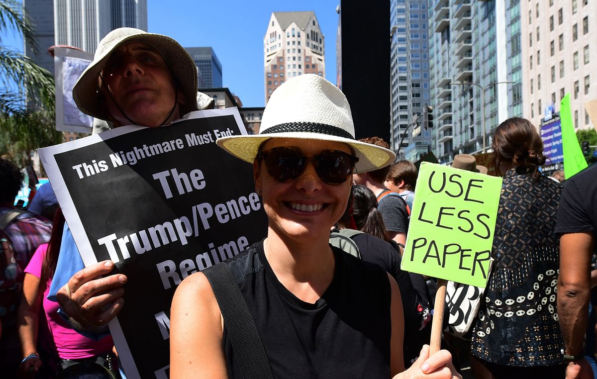 A woman makes her point with a small placard joining thousands of youth demanding action during a Climate Change protest in downtown Los Angeles, California on 20 September 2019, as part of a global protest happening around the world. Photo: AFP
