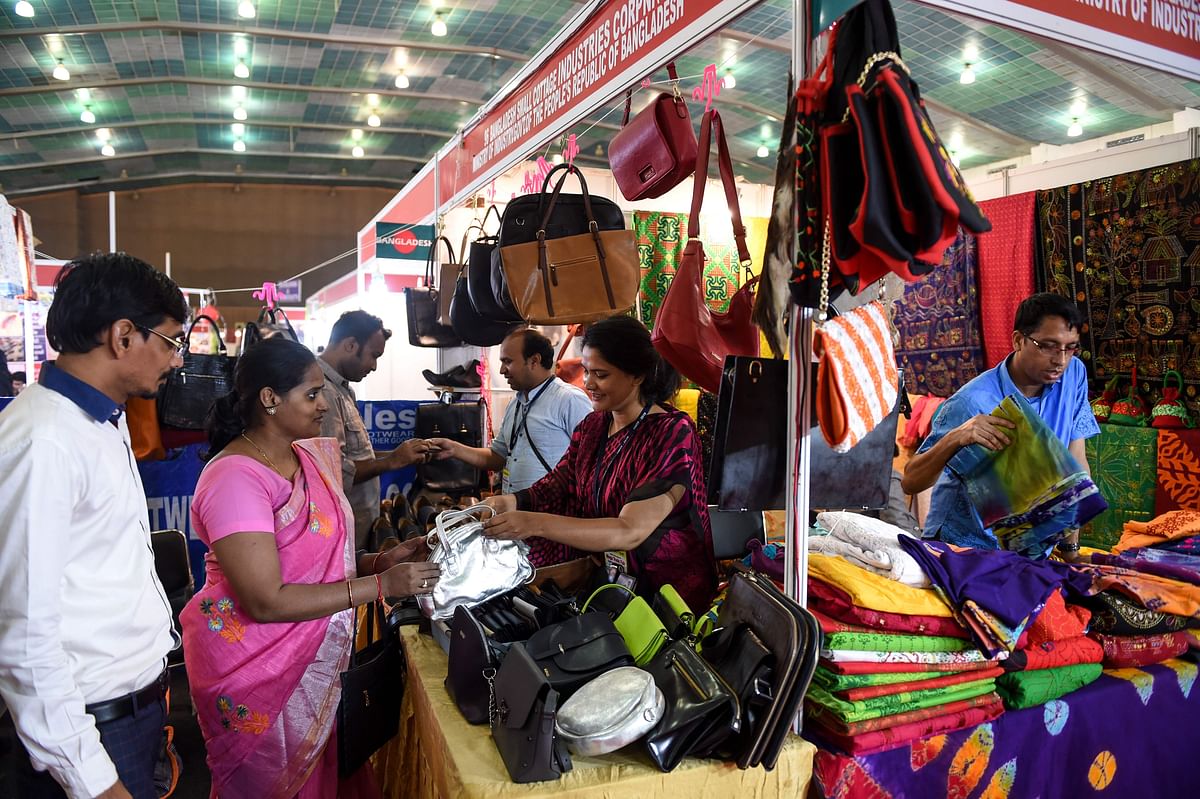 A customer looks at a purse at a Bangladesh Small Cottage Industries Corporation stall during the ongoing India International Mega Trade Fair (IIMTF) at the GMDC Ground Convention hall in Ahmedabad on 20 September 2019. Photo: AFP