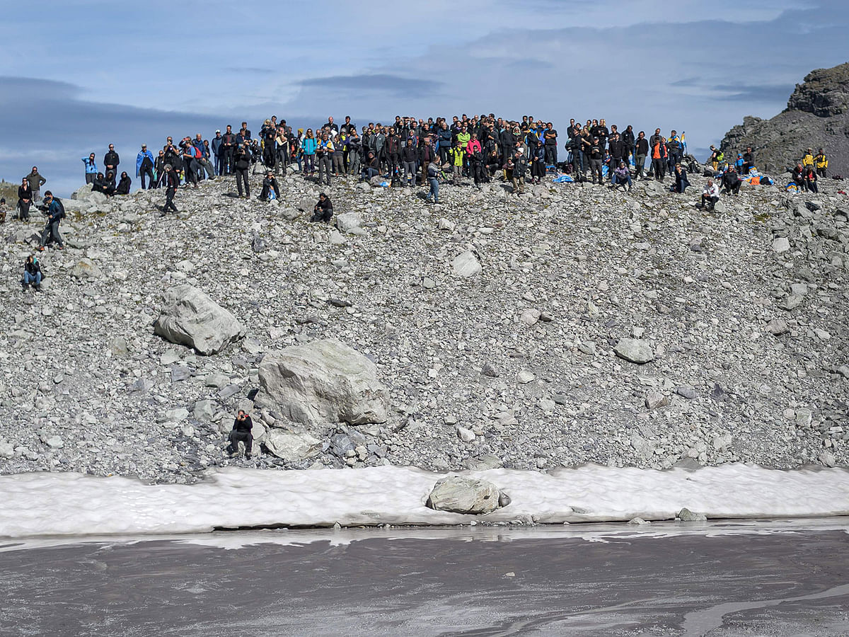 People take part in a symbolic farewell ceremony to mark the `death` of the Pizol glacier (Pizolgletscher) on 22 September 2019 above Mels, eastern Switzerland. In a study released earlier this year, researchers of the ETH technical university in Zurich determined that more than 90 percent of Alpine glaciers will disappear by 2100 if greenhouse gas emissions are left unchecked. Photo: AFP