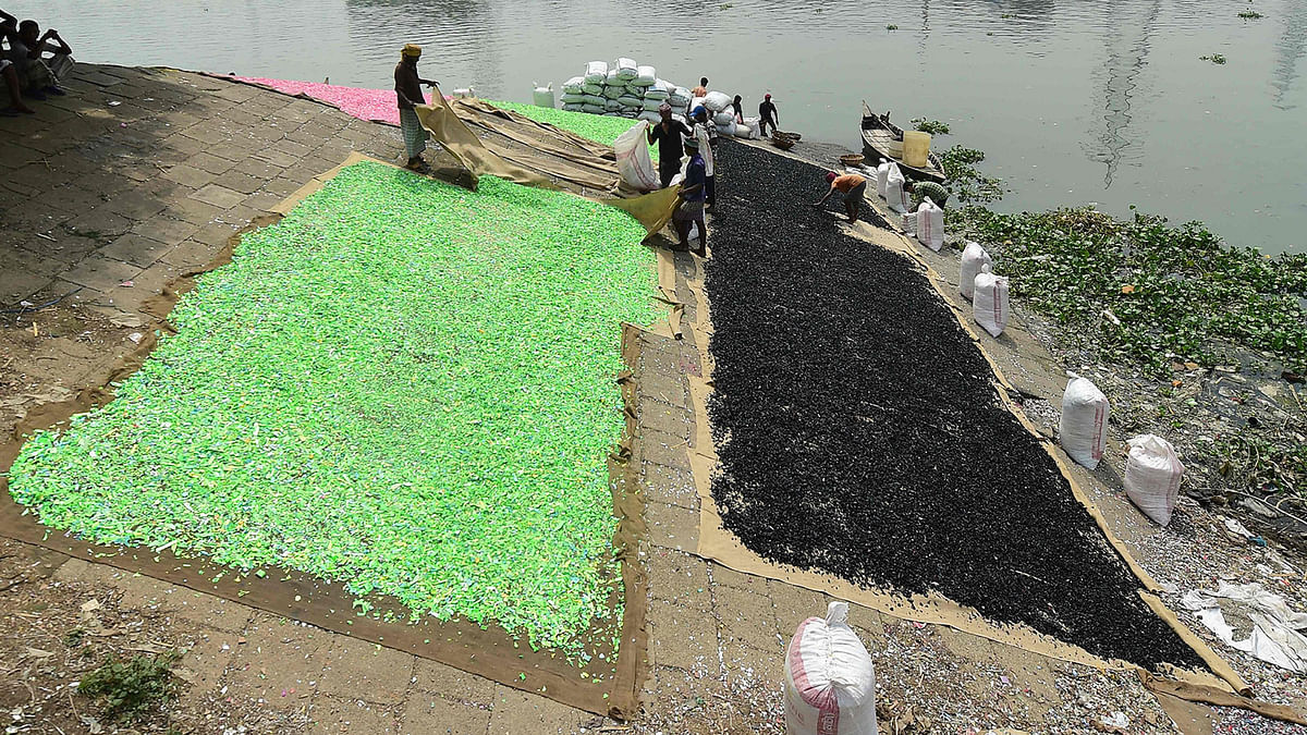 Workers sort out recycled plastic along the banks of the Buriganga river in Dhaka on 22 September 2019. Photo: AFP