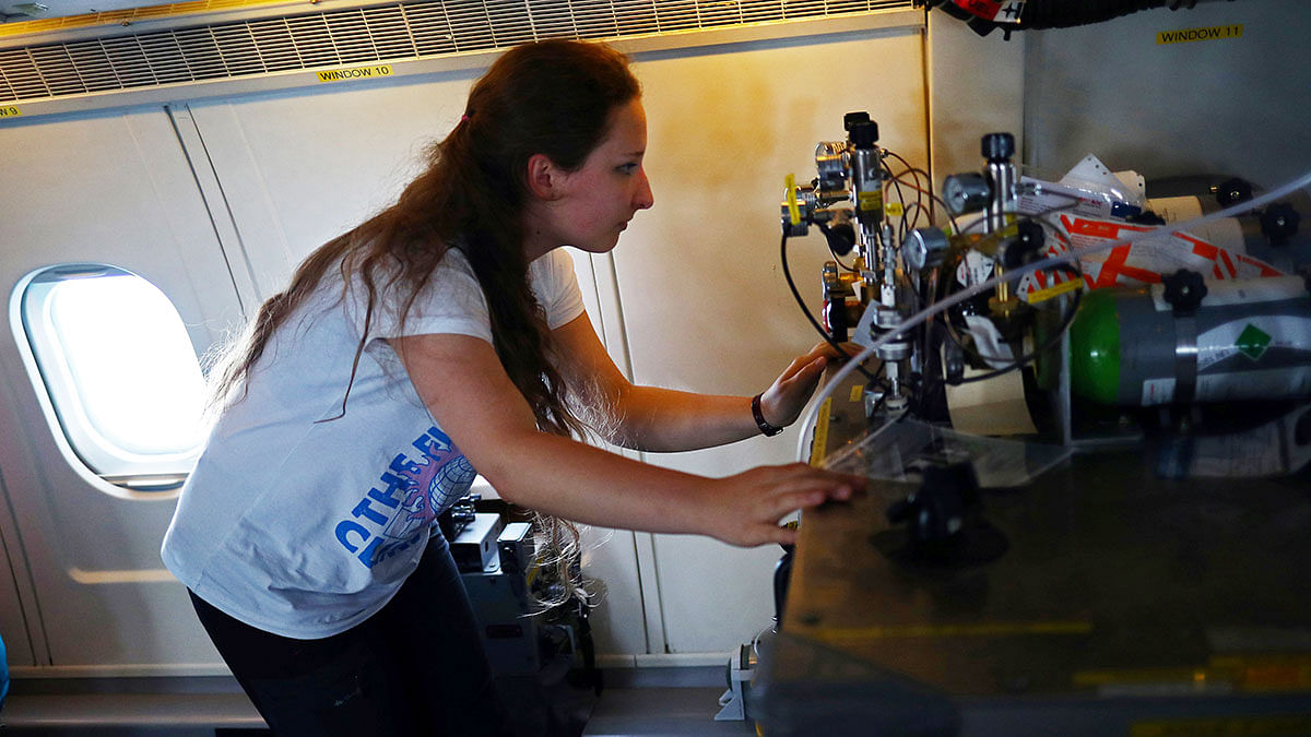 Dominika Pasternak, a PhD student in atmospheric chemistry at Britain`s University of York, checks equipment onboard an atmospheric research aircraft en route to the Norwegian Sea from northern Sweden. Photo: Reuters