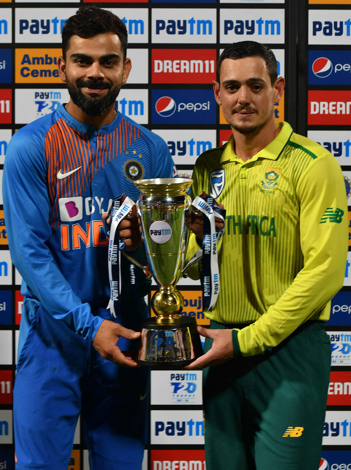 Indian cricket team captain Virat Kohli (L) and South African captain Quinto de Kock (R) share the trophy after the third Twenty20 international cricket match of a three-match series between India and South Africa ended with a draw, at the M. Chinnaswamy Stadium in Bangalore on 22 September 2019. Photo: AFP