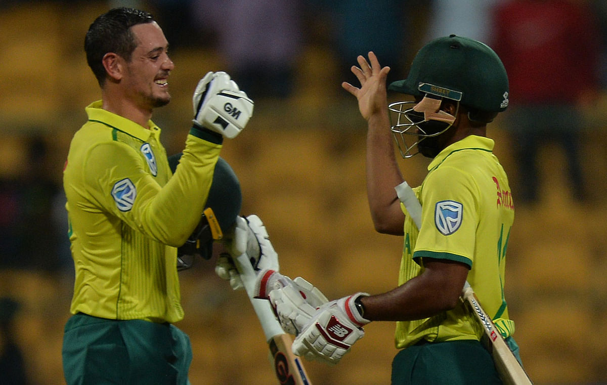 South African batsmen Temba Bavuma and captain Quinto de Kock celebrate their victory during the third Twenty20 international cricket match of a three-match series between India and South Africa at the M Chinnaswamy Stadium in Bangalore on 22 September 2019. Photo: AFP