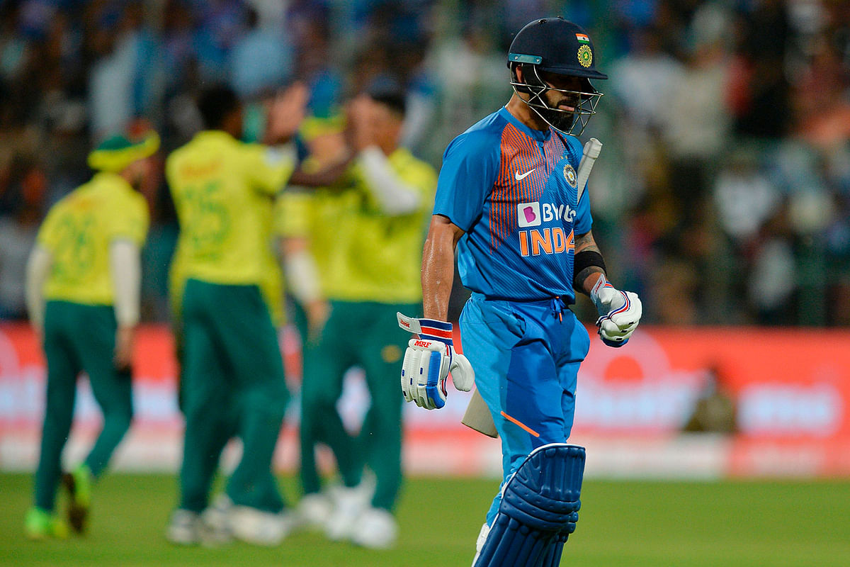 Indian batsman and captain Virat Kohl walks back to the pvilion after being dismissed for 9 runs during the third Twenty20 international cricket match of a three-match series between India and South Africa at the M Chinnaswamy Stadium in Bangalore on 22 September, 2019. Photo: AFP