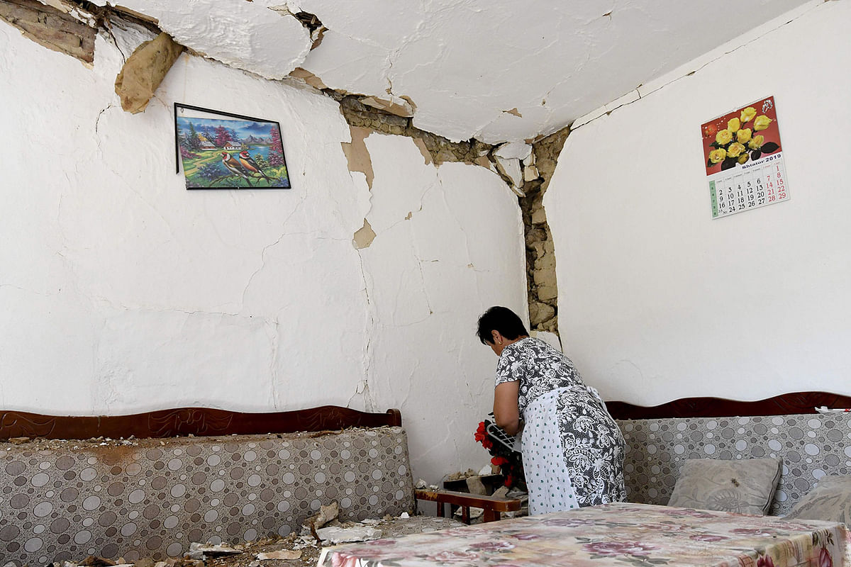 A woman cleans debris from her damaged house in the village of Zhurje near Tirana on 21 September 2019 after two earthquakes over 5.0 magnitude struck the coastline Adriatic coastline of Albania. Photo: AFP