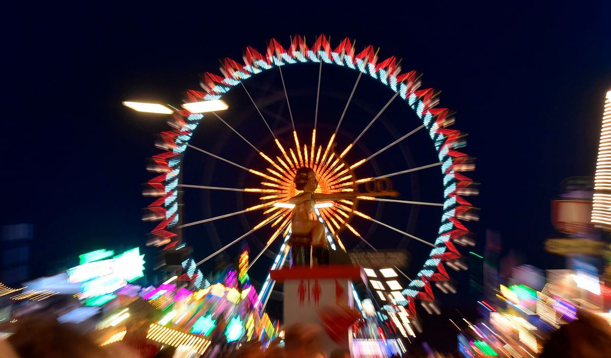 A Ferris wheel is illuminated at the Theresienwiese fair grounds during the opening day of the Oktoberfest beer festival in Munich, southern Germany, on 21 September 2019. The world`s biggest beer festival Oktoberfest will be running until 6 October 2019. Photo: AFP