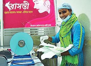 A woman poses with sanitary pads in her hands. File photo: Prothom Alo