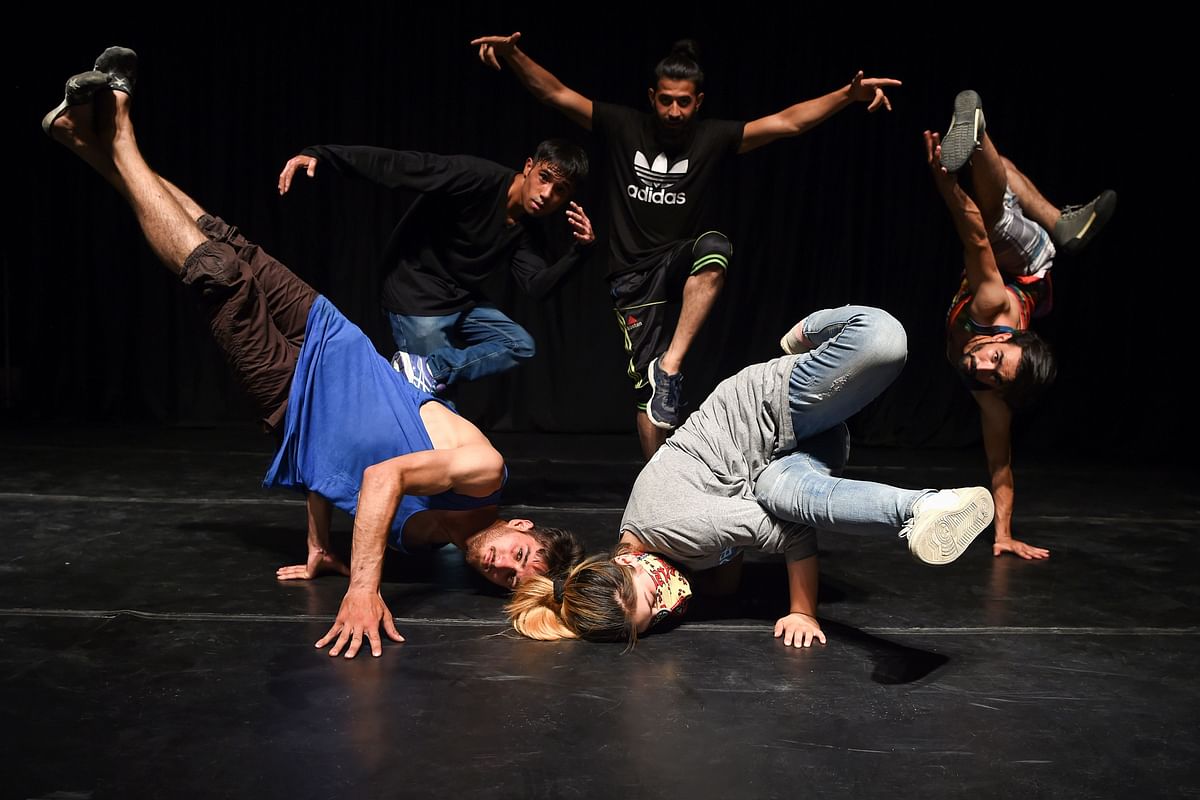 In this photo taken on 4 August 2019, Afghan breakdancers pose for a photograph at the French Cultural Centre in Kabul. In the land of suicide bombings, burqas, and unending war, a group of Afghans have turned to breakdancing for stress relief and self expression even as fears of a Taliban return to power spark worries of a renewed crackdown on the arts. Photo: AFP