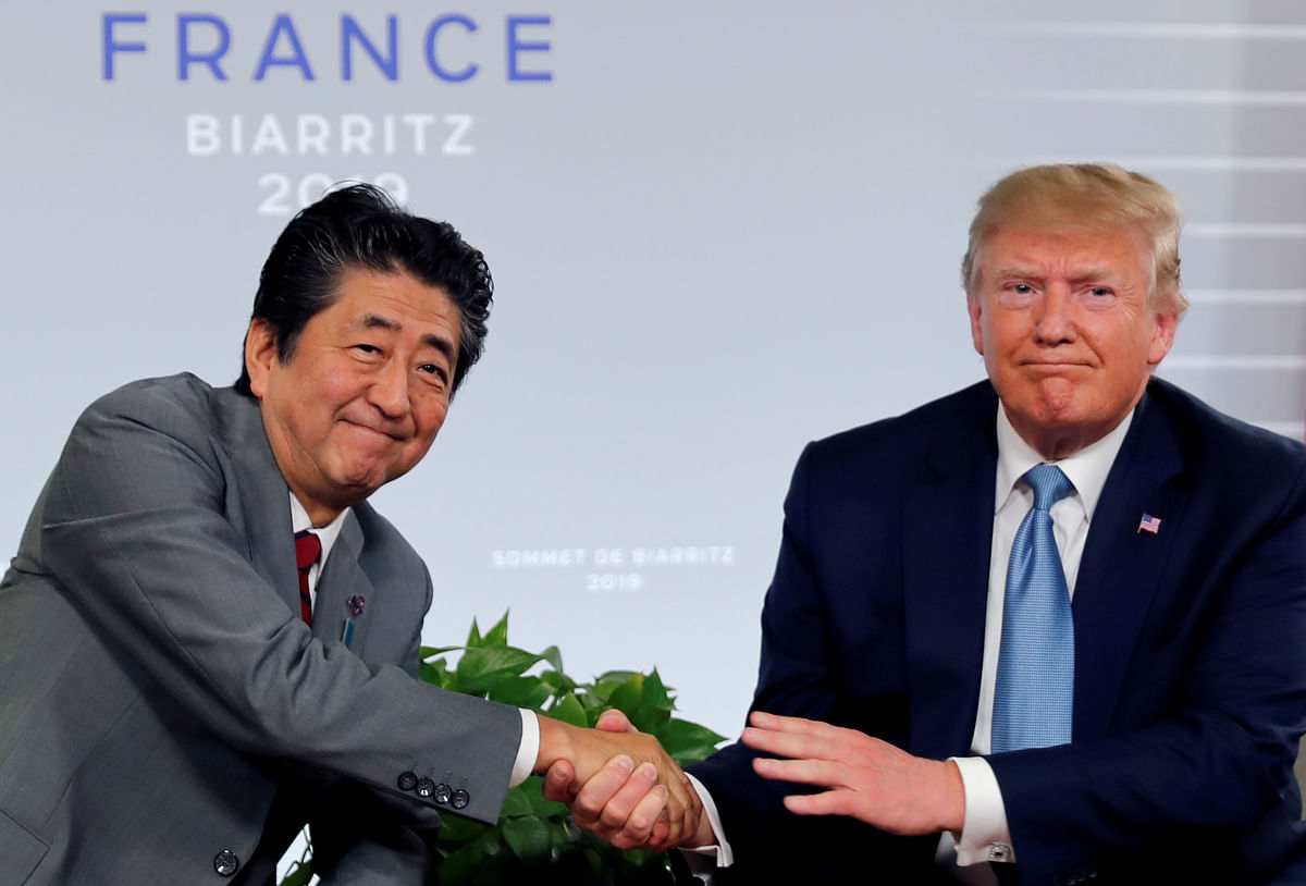 US president Donald Trump and Japan`s prime minister Shinzo Abe shake hands at a bilateral meeting during the G7 summit in Biarritz, France 25 August. Photo: Reuters