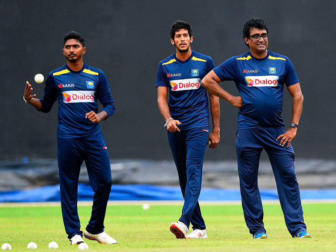 Sri Lanka`s Lakshan Sandakan (L), Kasun Rajitha and team coach Rumesh Ratnayake (R) look on during a practice session at the R. Premadasa Stadium in Colombo on 19 September 2019. Photo: AFP