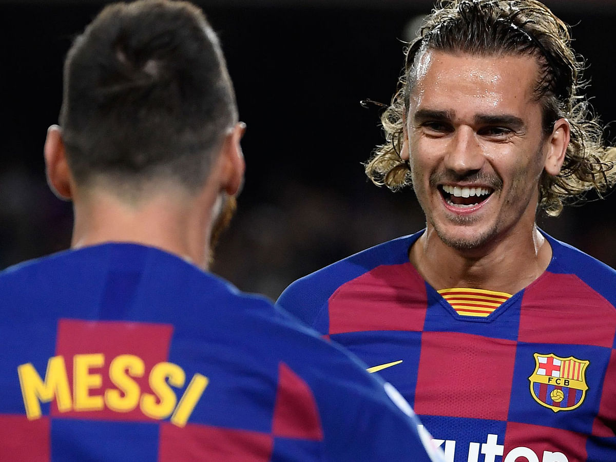 Barcelona`s French forward Antoine Griezmann (R) is congratulated by teammate Barcelona`s Argentine forward Lionel Messi after scoring the first goal during the Spanish league football match between FC Barcelona and Villarreal CF at the Camp Nou stadium in Barcelona, on 24 September 2019. Photo: AFP