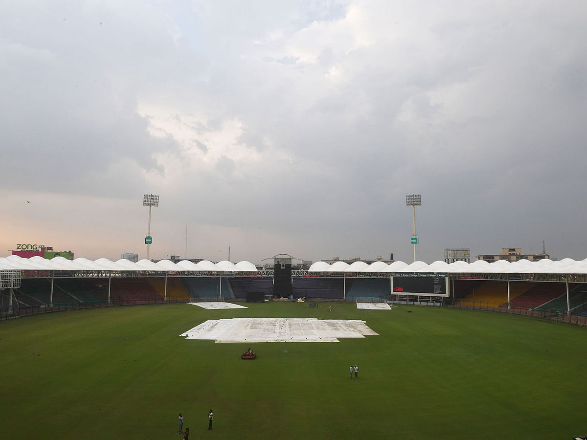 Pakistan`s Cricket Board (PCB) official stand in the National Stadium after the team practice was postponed due to rain in Karachi on 25 September, 2019. Photo: AFP