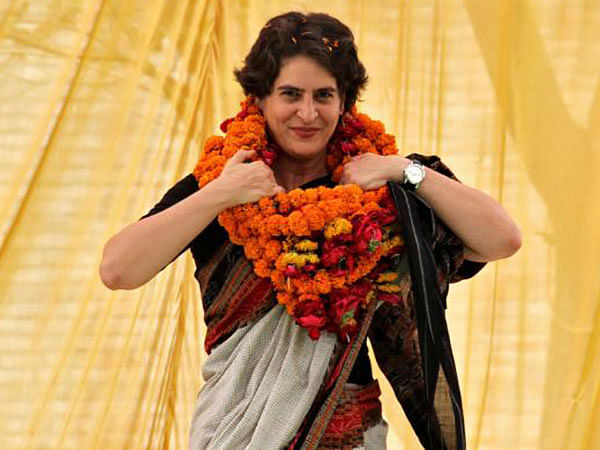 Priyanka Gandhi Vadra, daughter of India`s ruling Congress party chief Sonia Gandhi, adjusts her flower garlands as she campaigns for her mother during an election meeting at Rae Bareli in the northern Indian state of Uttar Pradesh on 22 April 2014. Reuters File Photo