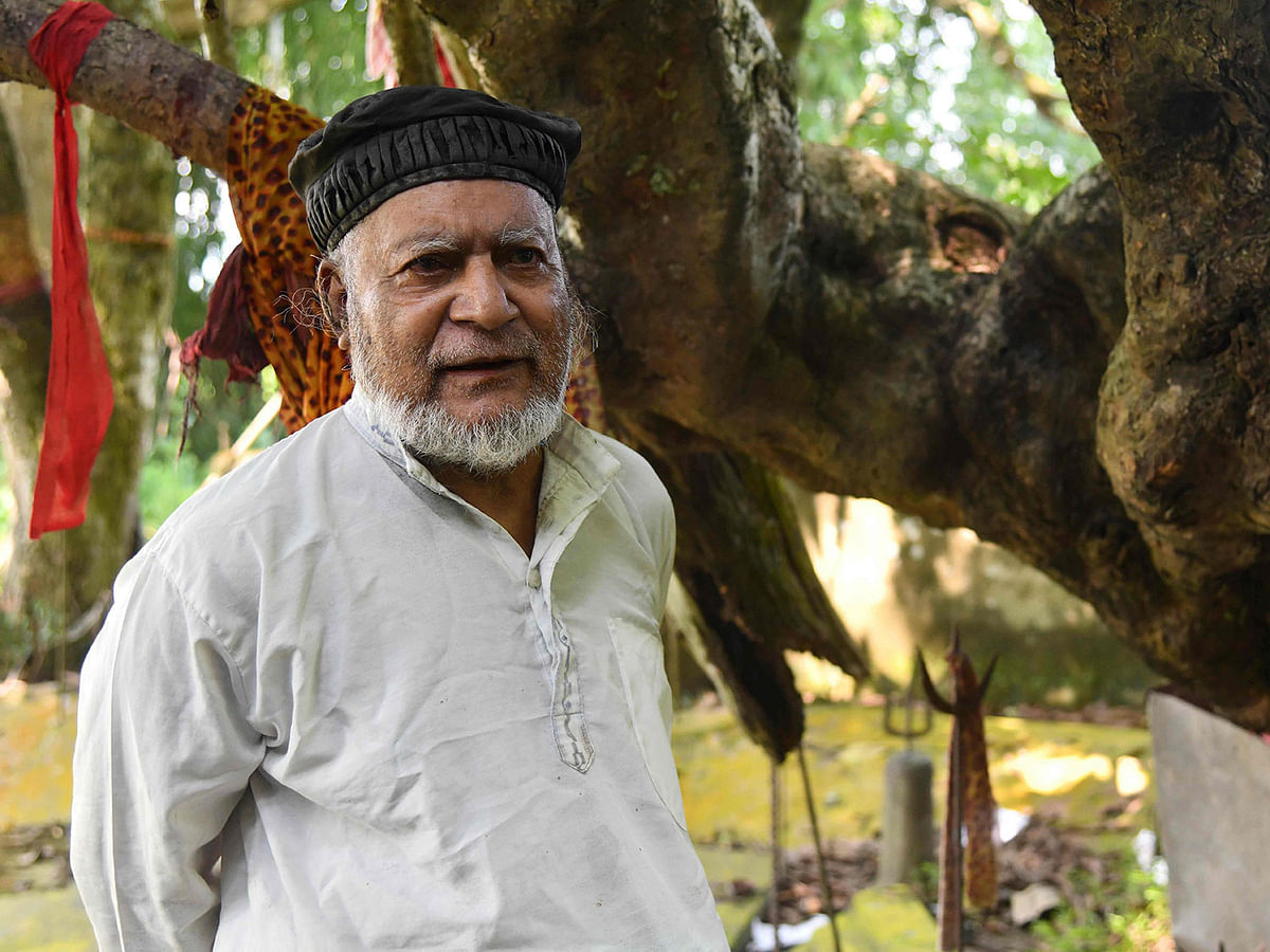 This photo taken 21 September 2019, shows Muslim caretaker Motibar Rahman, 73, standing by a shrine to the Hindu deity Shiva in Rangmahal village on the outskirts of Guwahati, the capital city of India’s northeastern state of Assam. Even in the tipsy-turvy world of Indian religion, Motibar Rahman stands out as a Muslim looking after a Hindu shrine -- as his family has done for centuries on the orders of Lord Shiva himself. Photo: AFP