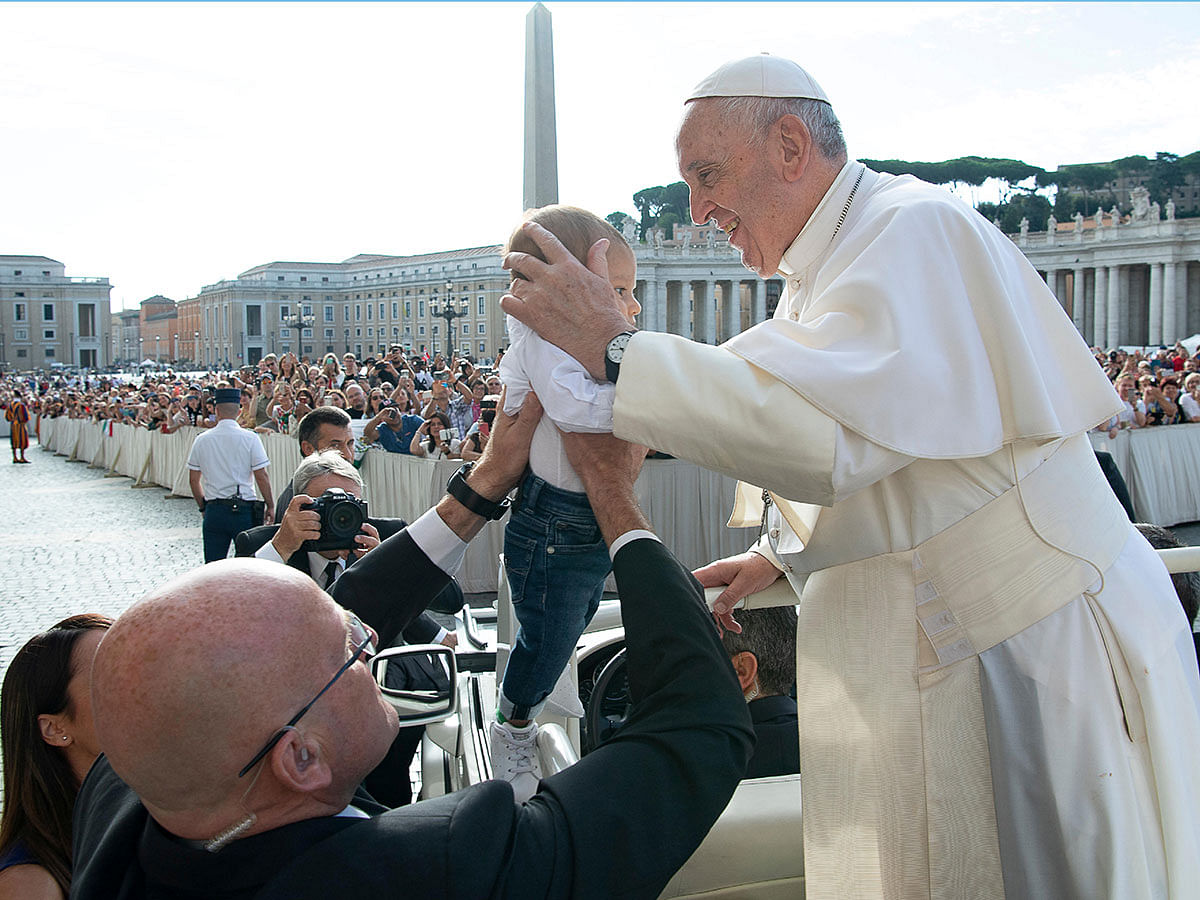 Pope Francis greets a baby during the weekly general audience at the Vatican, on 25 September 2019. Photo: Reuters