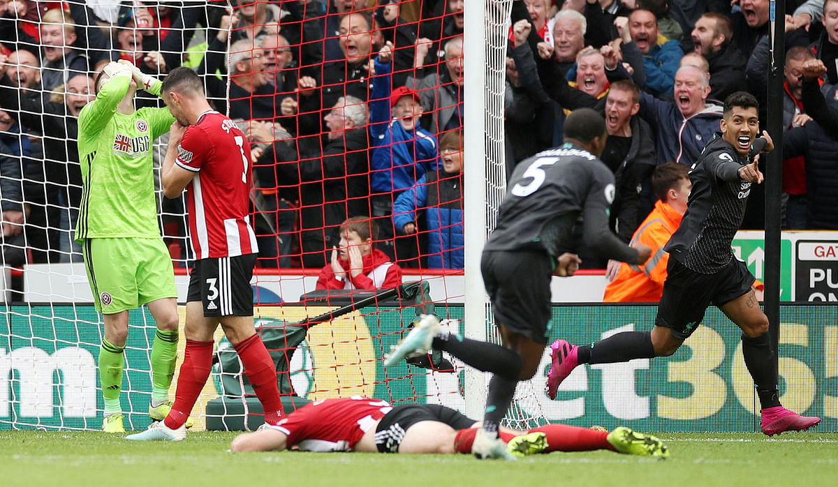 Liverpool`s Georginio Wijnaldum celebrates scoring their first goal with Roberto Firmino as Sheffield United`s Dean Henderson and team mates look dejected. Photo: Reuters