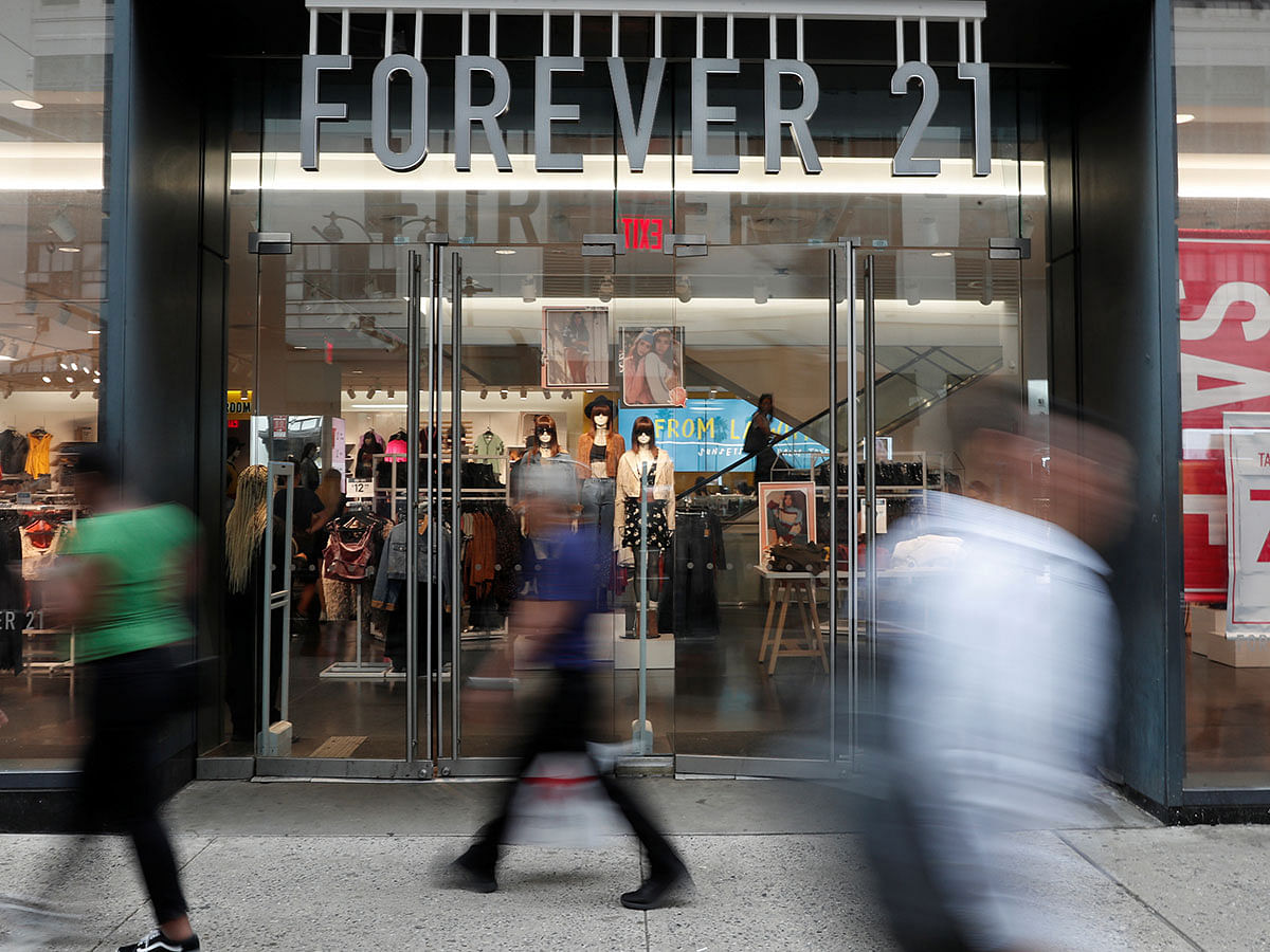 People walk by the clothing retailer Forever 21 in New York City, US on 12 September. Photo: Reuters