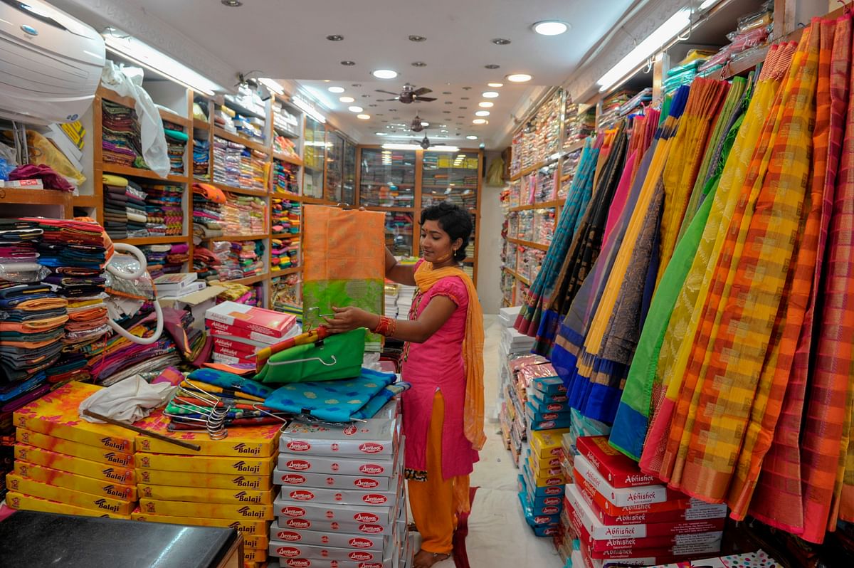 In this photograph taken on 28 September 2019, a vendor arranges sarees inside at a shop ahead of upcoming Hindu `Dushhera-Vijaya Dashami` festival, marking the end of `Durga Puja` that honours goddess Durga`s victory, in Hyderabad. Photo: AFP